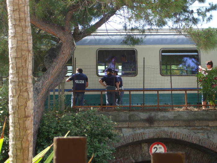 Italian motorcycle policemen investigating a death on the railway line.