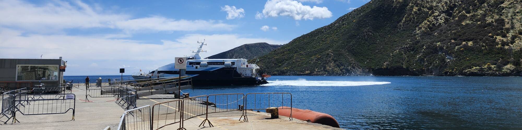 High-speed ferry turning after pulling away from the Vulcano port pier.