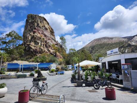 Businesses and rock formations in the port town on Vulcano.