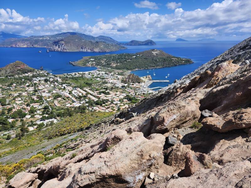 View down the steep slope over the town toward other islands.