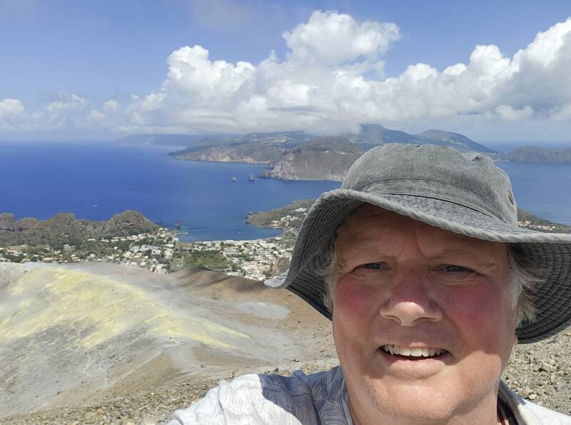 Me at the peak, islands and sea and clouds in the background.