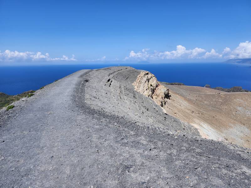 People walking along the crater rim in the distance.