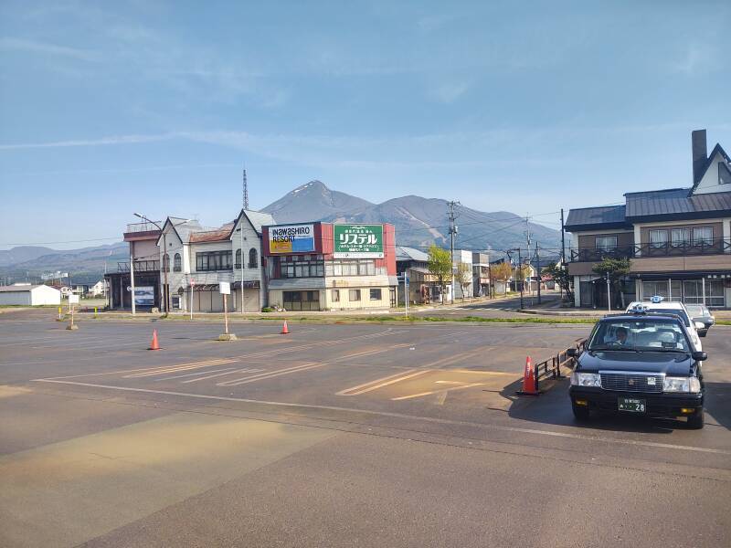 Parking lot at Inawashiro Station, Mount Bandai in the distance.