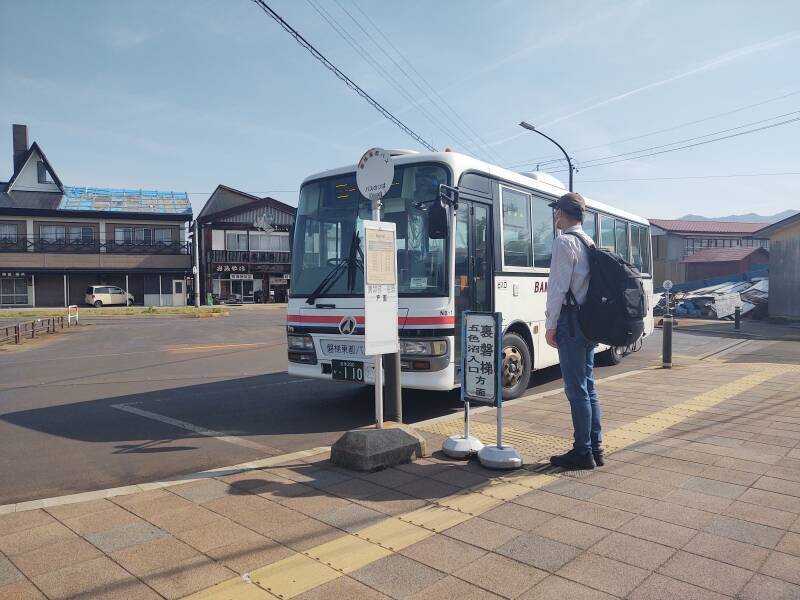 Bus pulls into parking lot at Inawashiro Station.