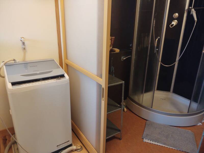 Shower and laundry room at Mooi Guesthouse in Aizu-Wakamatsu.