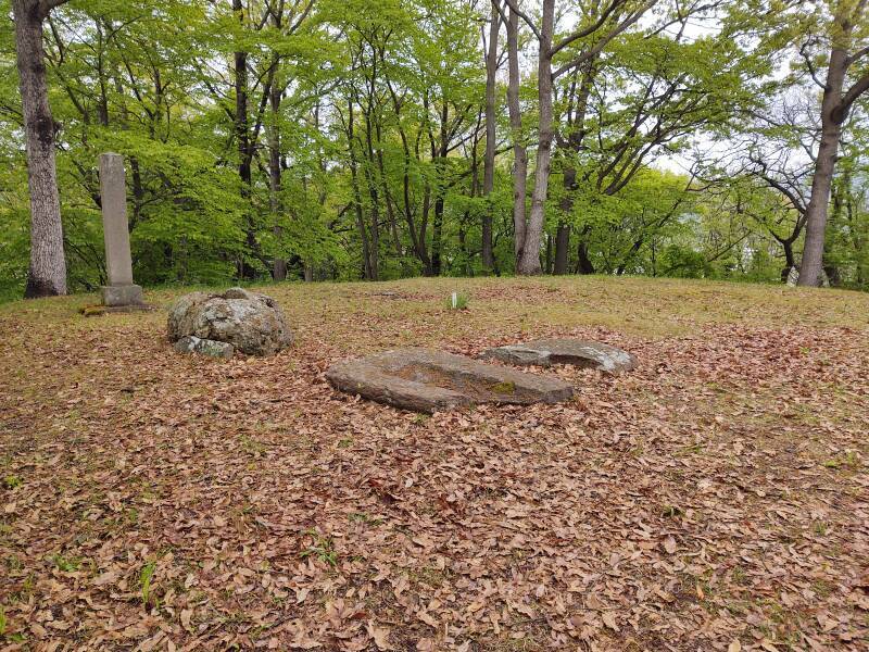 Stone tomb cover and modern monument on upper mound of Ōtsukayama Kofun in Aizu-Wakamatsu.