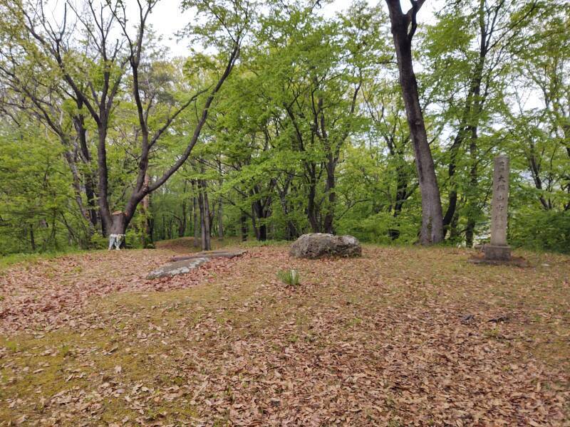 Stone tomb cover and modern monument on upper mound of Ōtsukayama Kofun, looking toward lower wedge-shaped section.