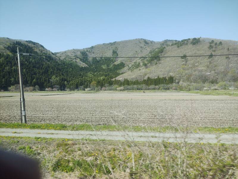 Farm fields and low mountains along the Ban-Etsusai Line from Kōriyama Station to Aizu-Wakamatsu.