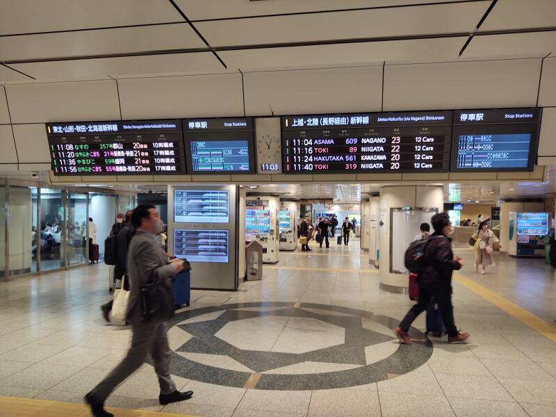 Overhead sign showing Shinkansen schedules and tracks Tōkyō Station.