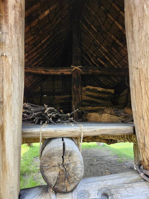 View into large structure with floor elevated above ground level.