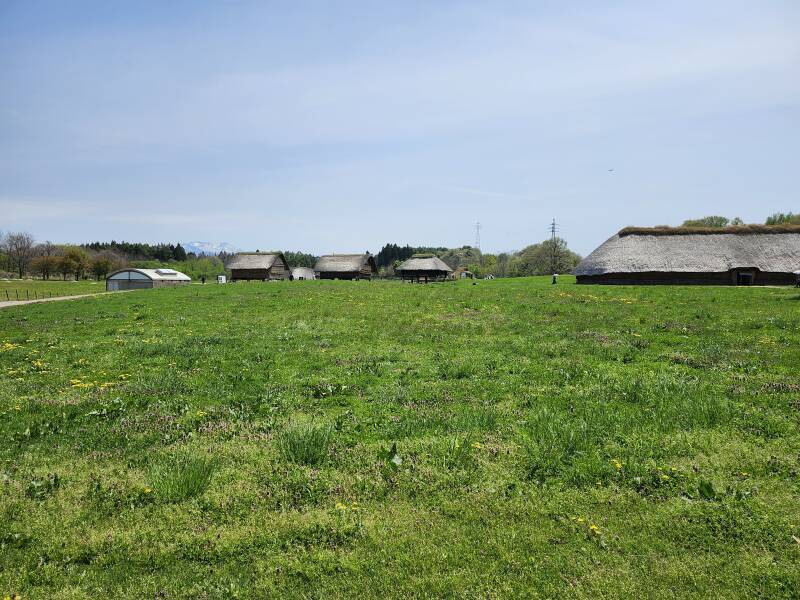 Multiple large reconstructed Jōmon structures.