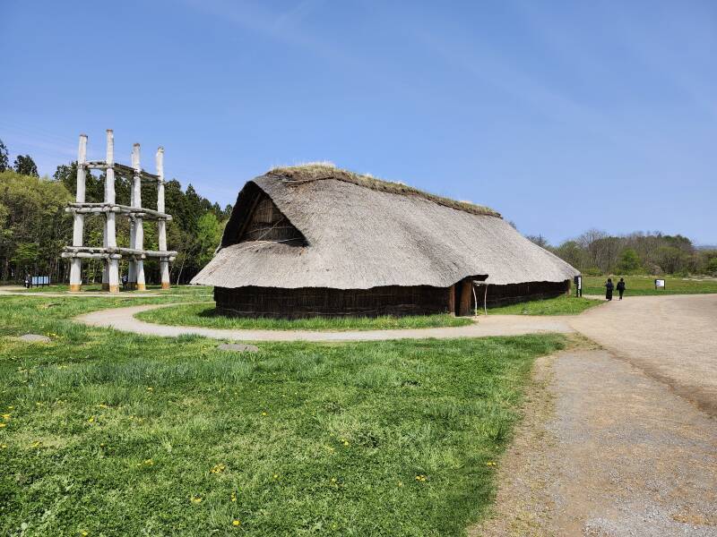 Largest communal structure with six-pole three-deck tower behind it.