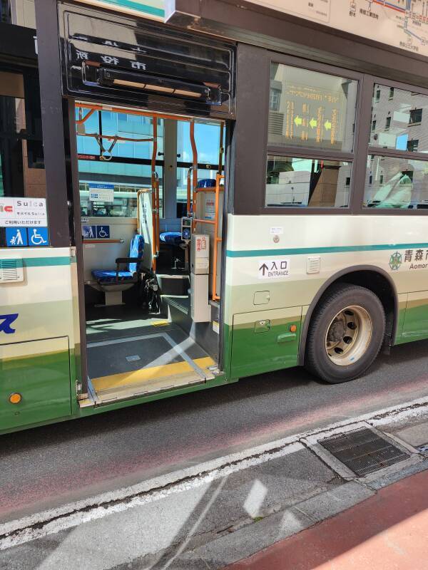 The E10 bus arrives — board at the back and take a ticket.