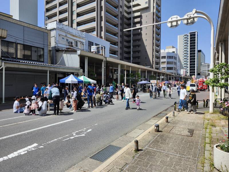 People walking down the blocked-off Shinmachi-dori.