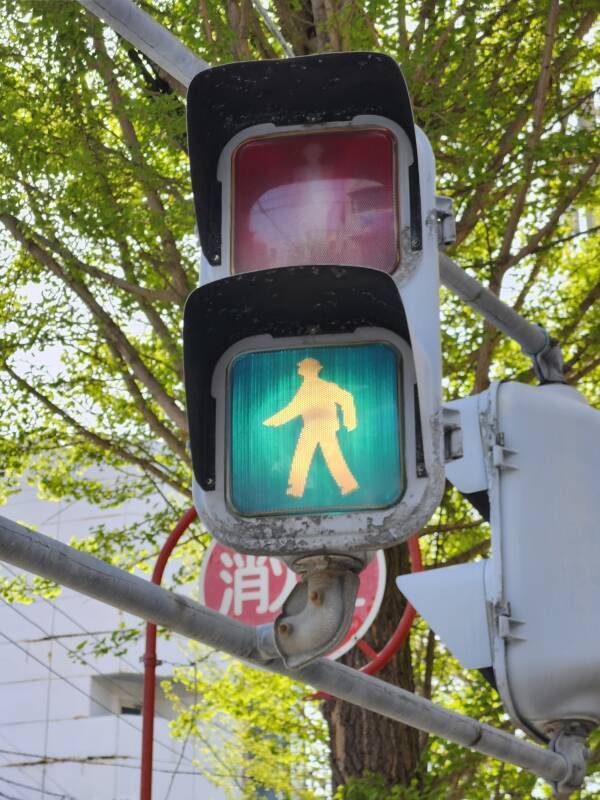 Blue 'walk' pedestrian signal light.