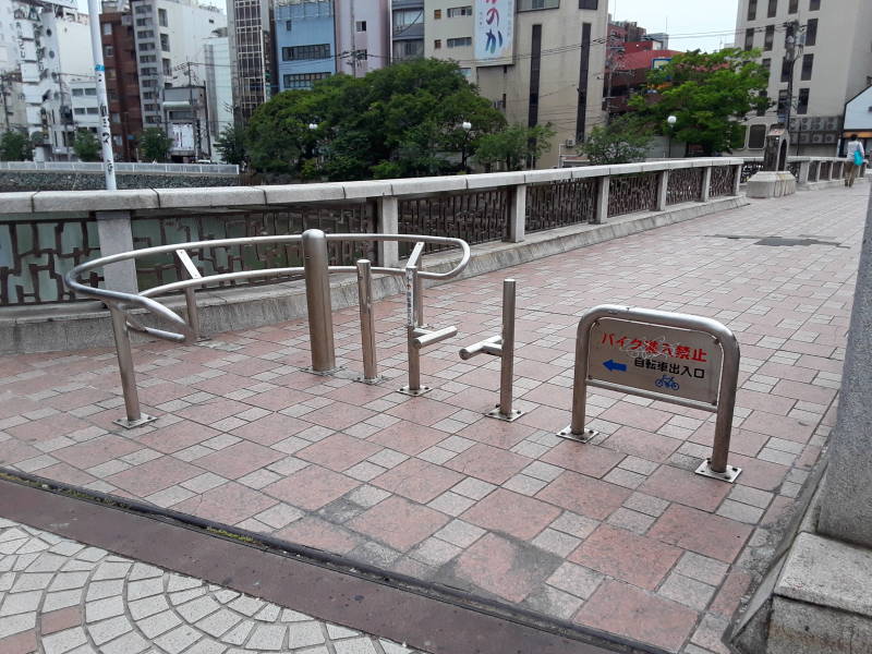 Gates for bicycles and carts on a bridge in Fukuoka.