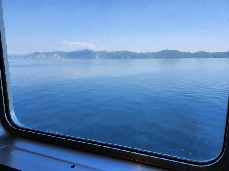 View through salt-obscured porthole.