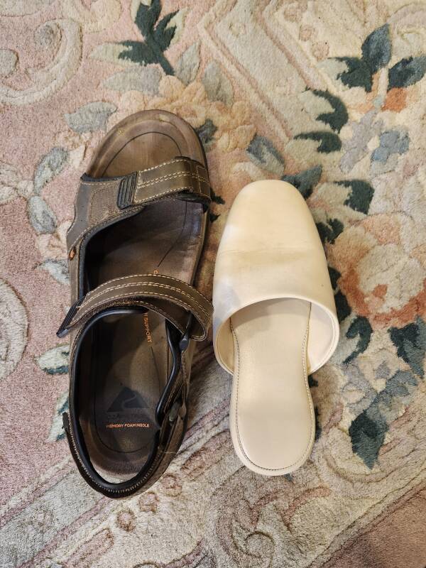 My U.S. size 13 sandals alongside the much smaller hotel hallway slippers.