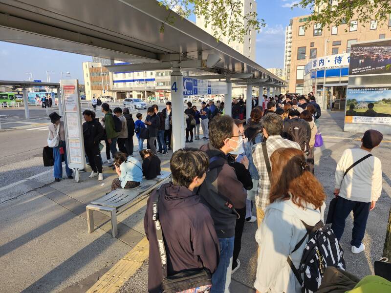 Large line of people waiting for the bus to the summit of Mount Haguro.