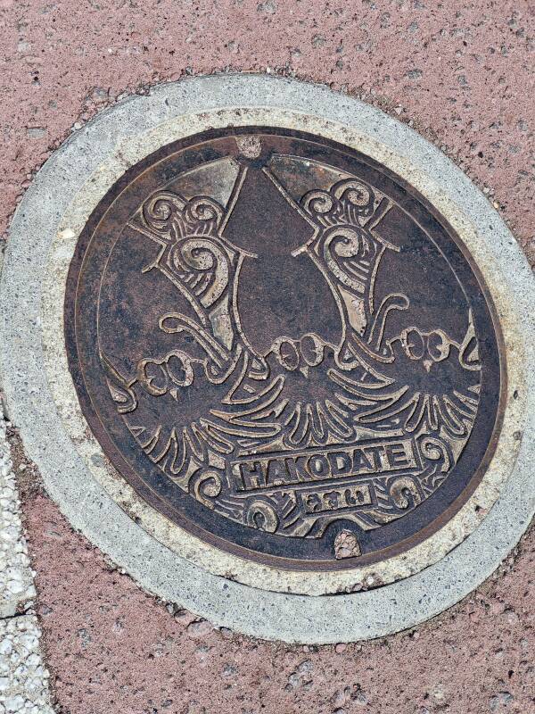 Manhole cover with Hakodate's squid mascot.