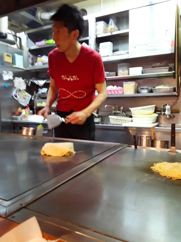 Okonomiyaki chef in Hiroshima, batter base and noodle base.