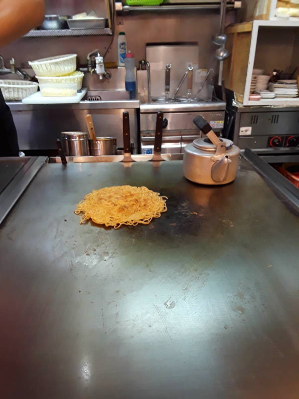 Okonomiyaki chef in Hiroshima, batter base and noodle base.