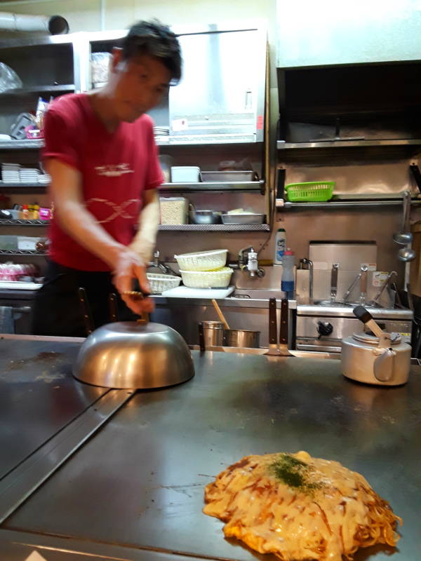 Okonomiyaki chef in Hiroshima, batter base and noodle base.