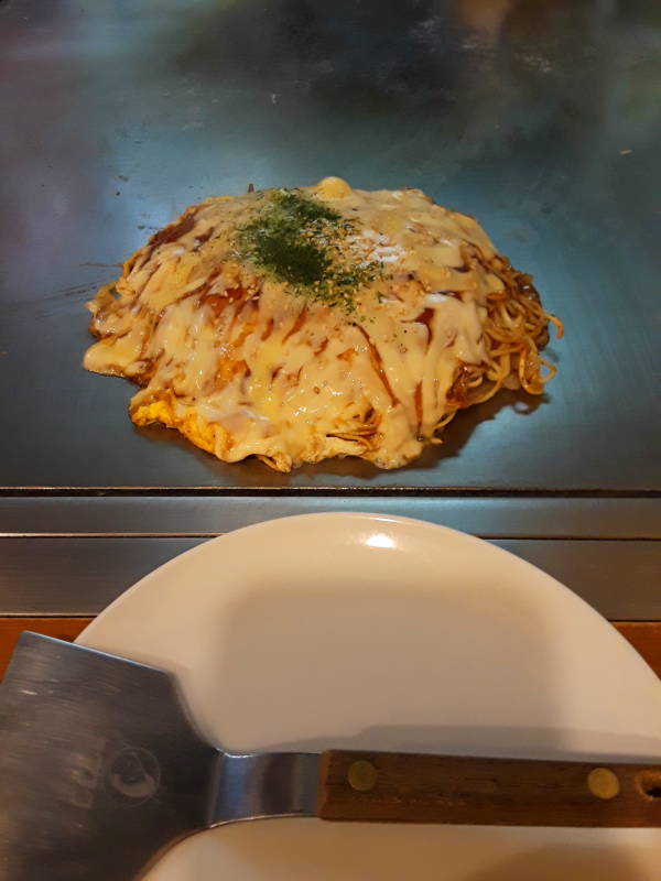 Okonomiyaki chef in Hiroshima, batter base and noodle base.