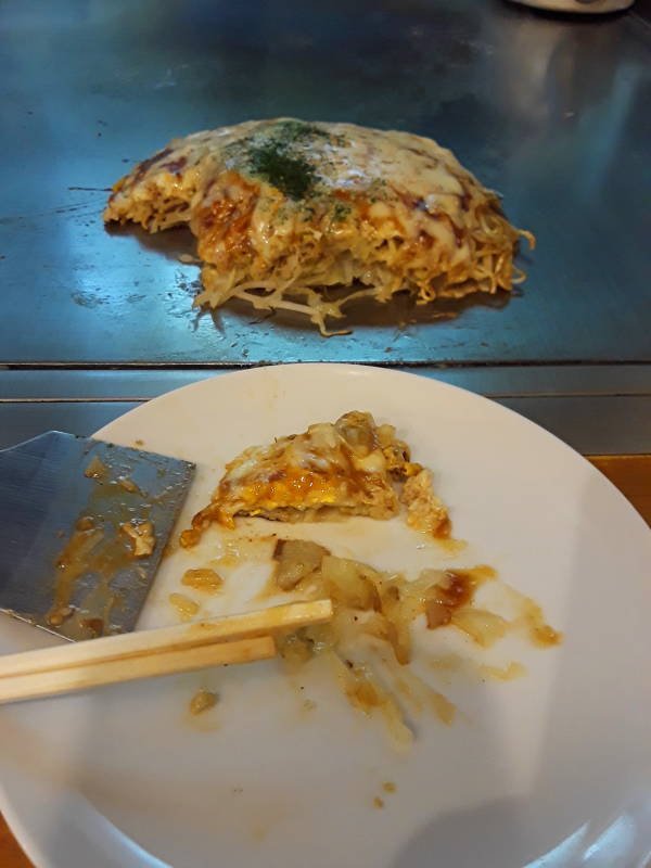 Okonomiyaki chef in Hiroshima, batter base and noodle base.