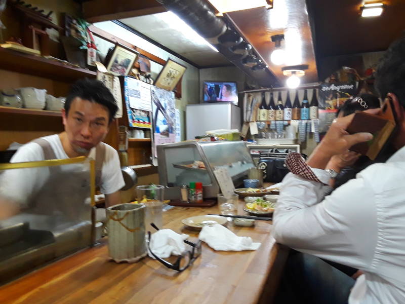 Sitting at the counter in a small izakaya in Ise, Japan.