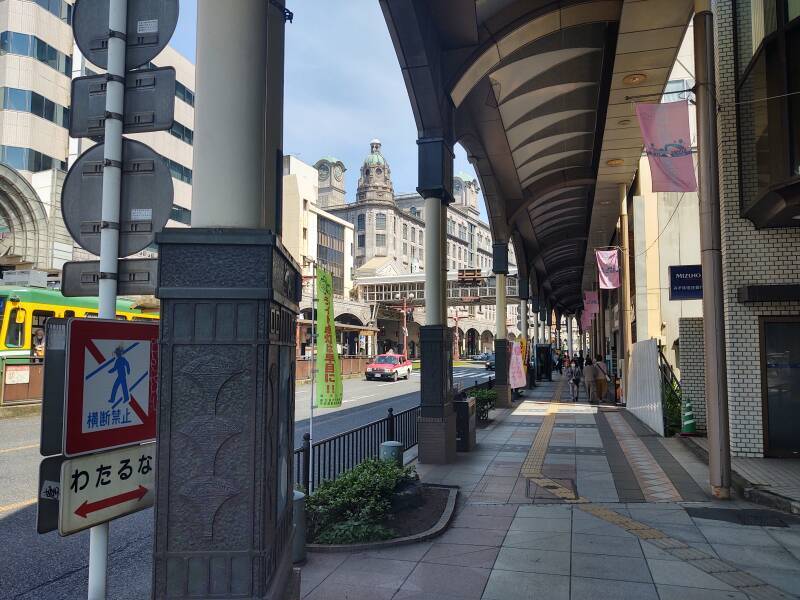 A covered sidewalk, approaching the Yamakataya department store.