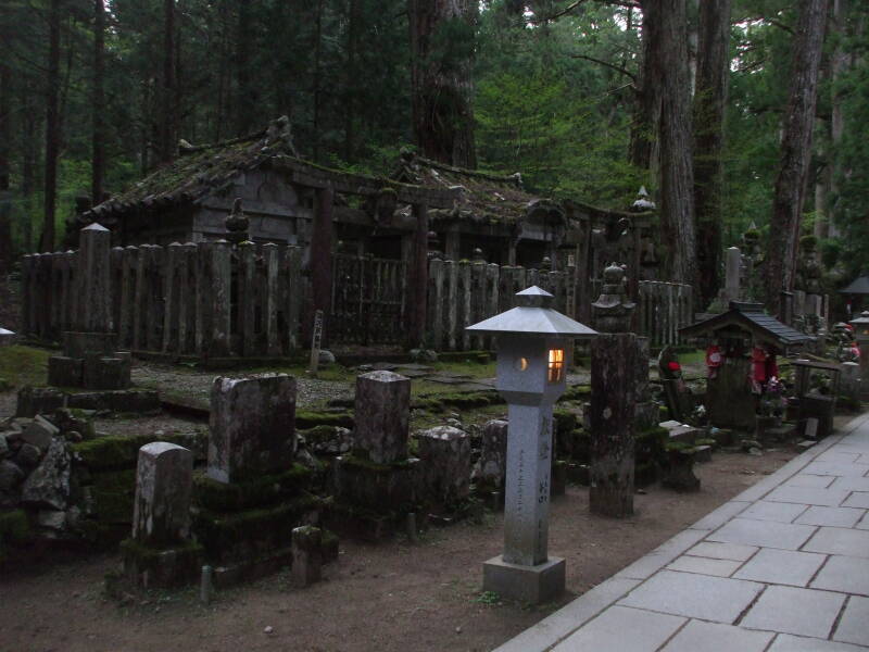 Path through the Okunoin cemetery in Kōya-san, lined with Buddhist tombs.