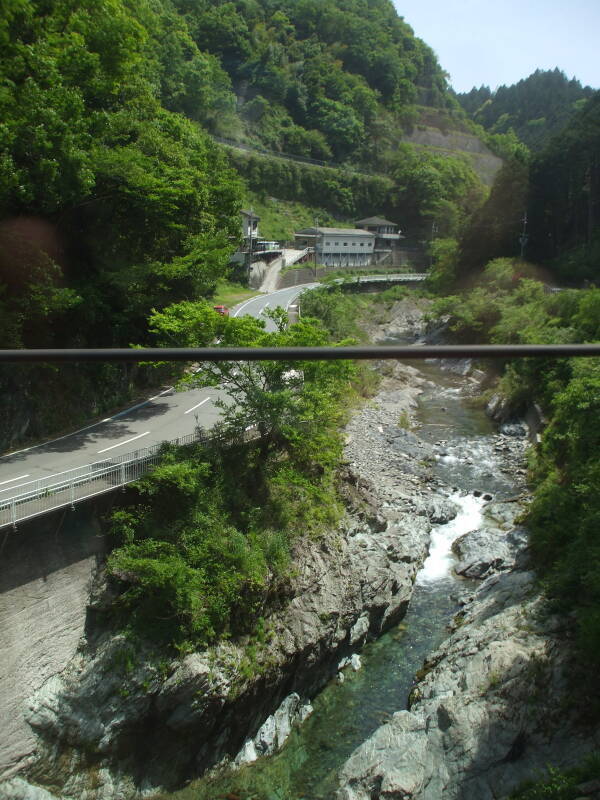View of waterfall and narrow highway from the train ascending from Hashimoto to Gokurakubashi Station and Kōya-san.