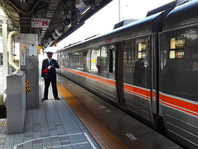 Uniformed platform attendant in the Express station in Nagoya.