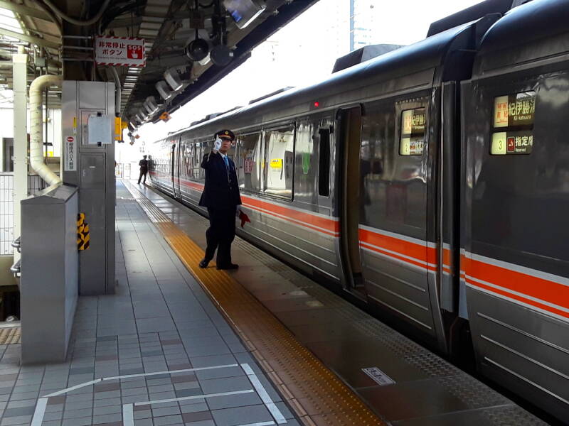 Uniformed platform attendant in the Express station in Nagoya.