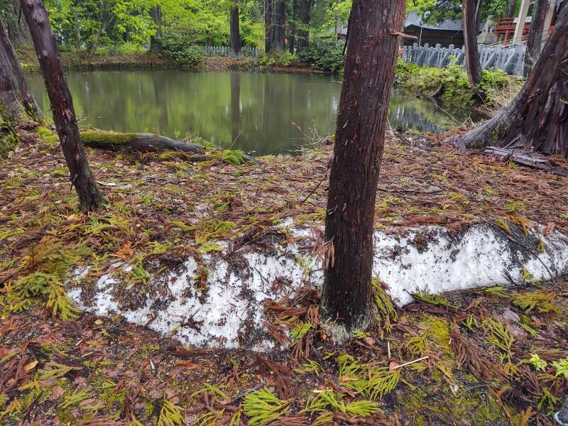Ceremonial pond near Dewasanzan-jinja, the main shrine, and a pile of snow.
