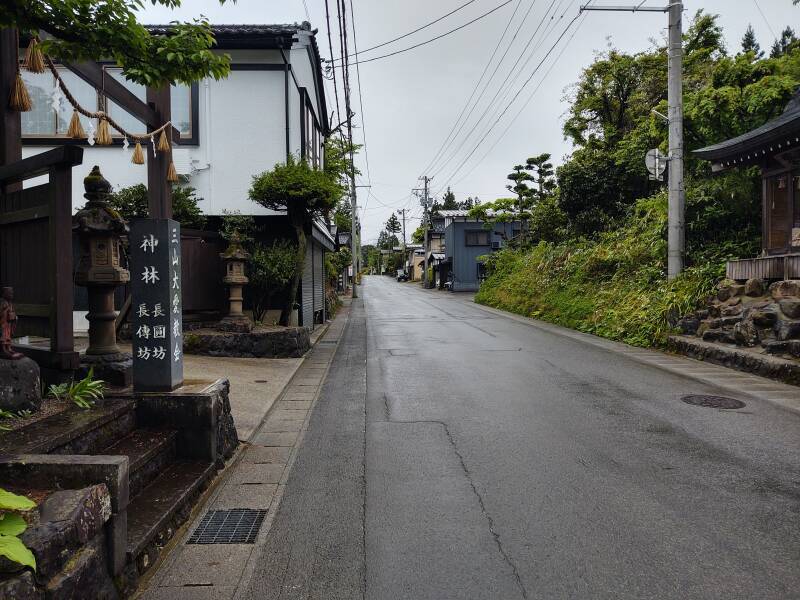 Main road through Haguromachi Touge, lined with guesthouses, private homes, and pilgrim lodges.