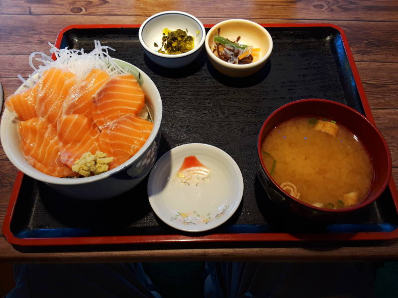 Salmon donburi, miso soup, and pickled vegetables at lunch in a cafe along the waterfront in Nagasaki harbor.