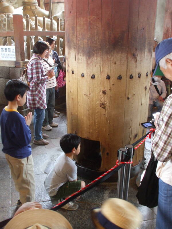 Children crawl through the pillar at Tōdai-ji, the Buddhist temple in Nara.