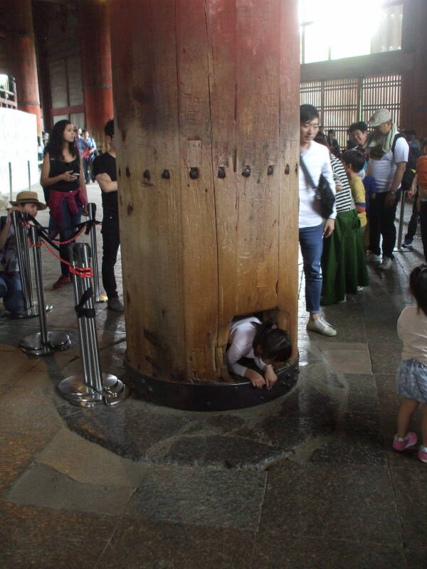 Children crawl through the pillar at Tōdai-ji, the Buddhist temple in Nara.