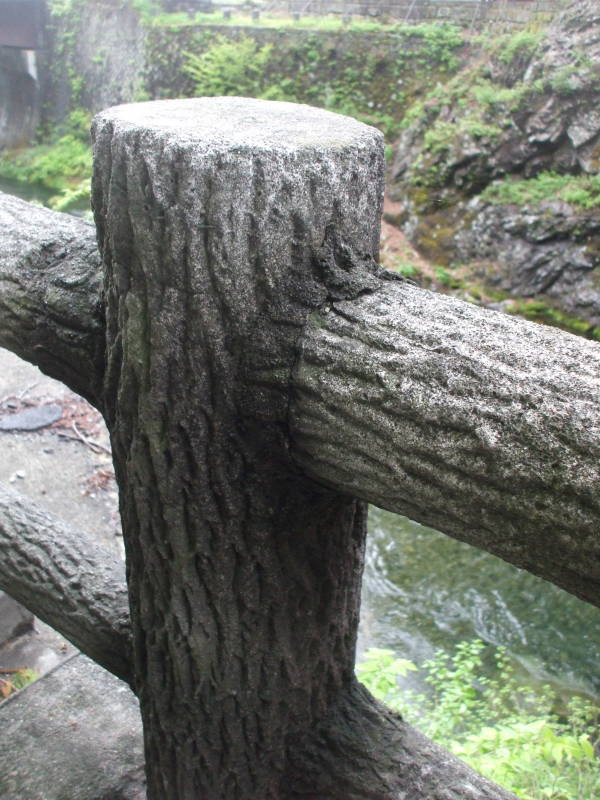 Concrete fence posts made to look like elm logs.