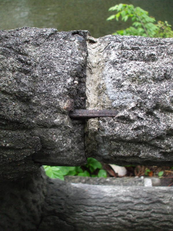 Concrete fence posts made to look like elm logs.