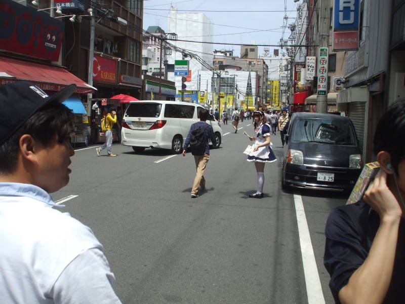 Girl in a maid costume promoting a maid cafe in Den-Den Town, electronics and otaku section of Osaka.