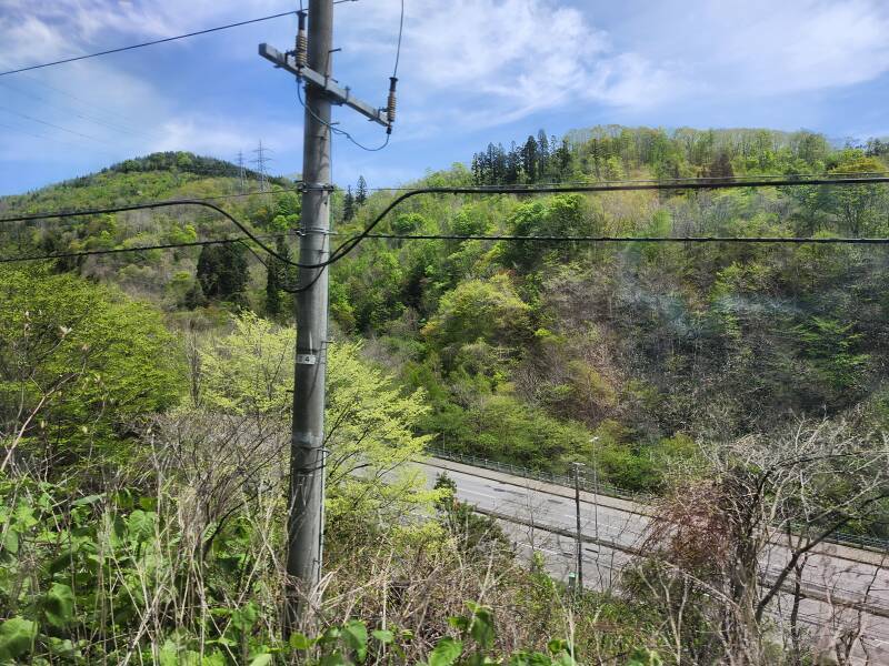 The highway north from Hakodate climbs into the mountains, the rail line runs above and to its side.