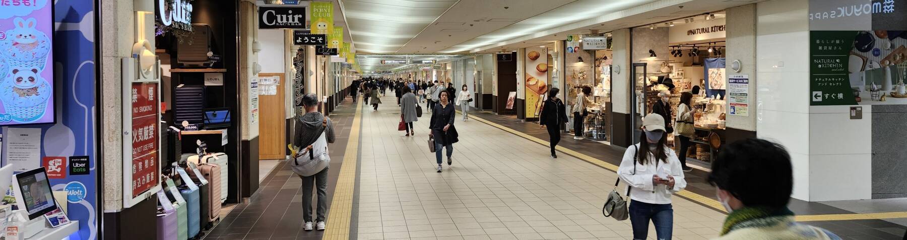 People walking through one of multiple kilometer-long subterranean shopping corridors beneath central Sapporo.