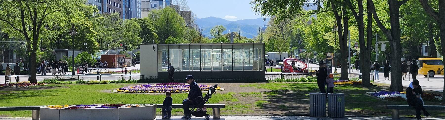 People enjoying a beautiful day in Odori Park in central Sapporo.