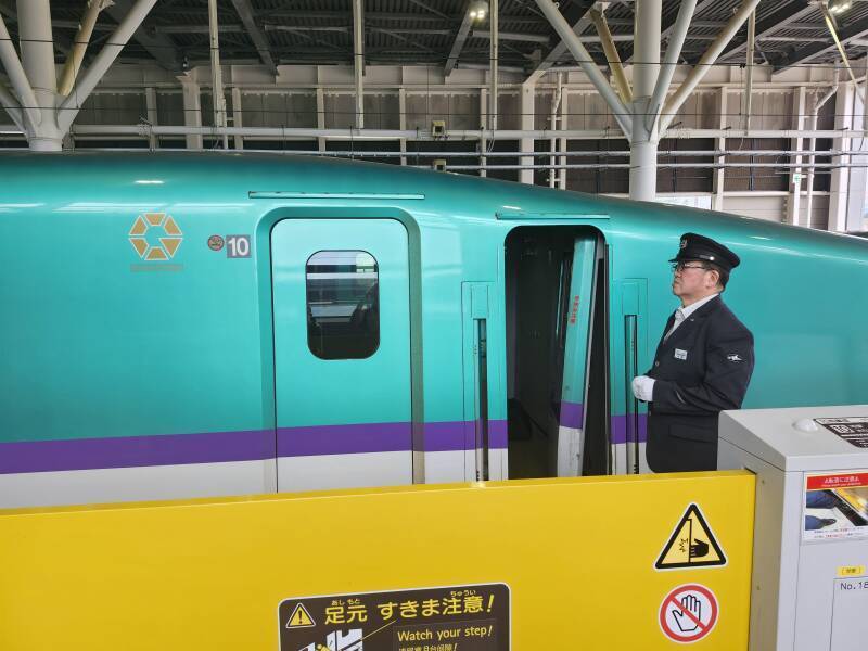 Train staff next to the entry to the engineer's compartment.