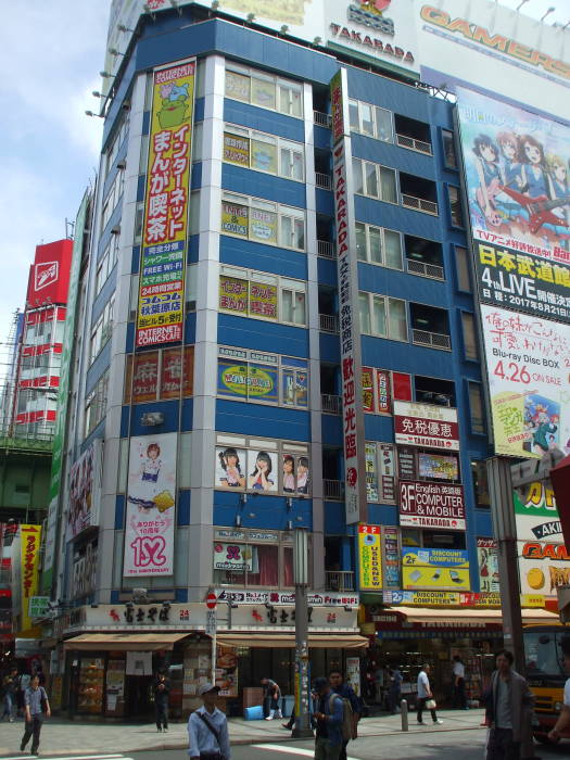 Tall building in Akihabara with a maid café.