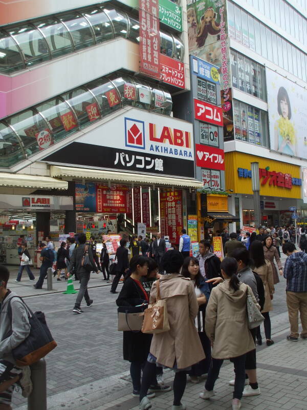 Exiting the south end of Akihabara Station, many people on the streets, bright signs overhead.