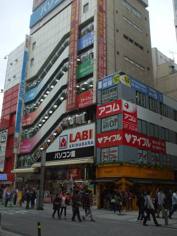 Brightly colored signs over busy streets in Akihabara.